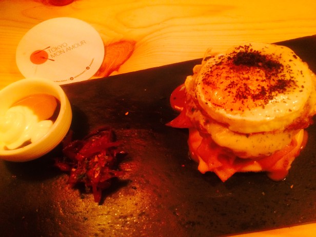 Ramen Croque Madame ( Bechamel, Chicken Ham & Cheese in a Guppy Ramen Bun topped with Cracked Fried Egg